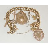 A gilt metal, hollow link curb bracelet, with attached 9ct gold shield fob with vacant cartouche,