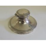A silver capstan inkwell, hallmarked for Birmingham 1917, liner missing, weighted base.