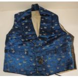 An early 20th Century gentlemans silk waistcoat, the front having flowers embroidered onto deep blue