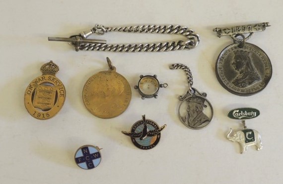 A brass On War Service badge 1915; a silver curb link watch chain; commemorative badges and other