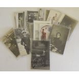 A quantity of loose postcards, military related including photographic of young boy in uniform
