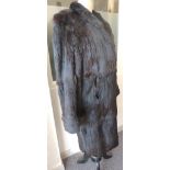 A ladies dark fur coat with wide cuffs and together with a ladies faux fur coat (2)