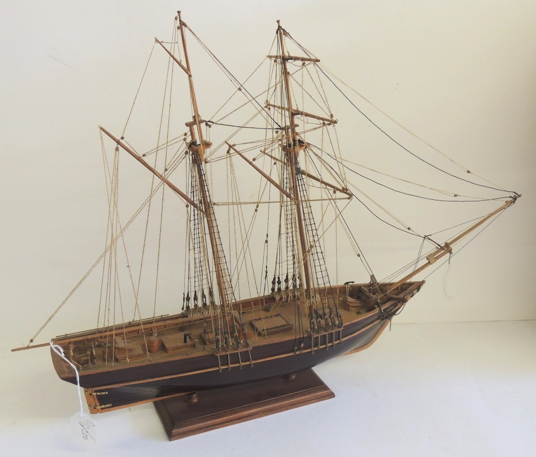 A well constructed wood model of a two masted sailing ship on stand, 20th Century, 46cms high