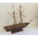 A well constructed wood model of a two masted sailing ship on stand, 20th Century, 46cms high
