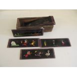 A group of 12 hand painted nursery magic lantern slides painted with assorted figures and animals in