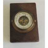 An early 20th Century desk barometer/paperweight, in rectangular leather covered case, 10.5cms x 7.