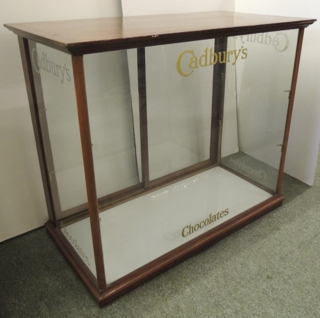 CADBURYS CHOCOLATES - a mahogany display cabinet, polished mahogany and with sliding glass rear