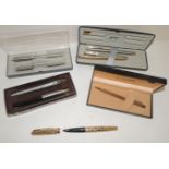 A Parker "61" fountain pen in textured gold metal case; a Parker gift set of fountain pen and ball