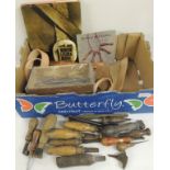 A quantity of leather working tools and some metal working tools, some small pieces of leather and