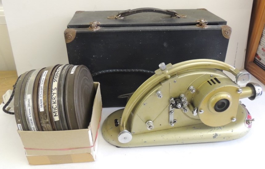 A Pathescope Gem 9.5mm projector in box together with 5 reels of Pathe film - cartoon including