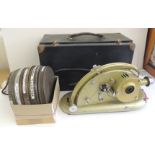 A Pathescope Gem 9.5mm projector in box together with 5 reels of Pathe film - cartoon including