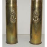 Two WWII brass shells with applied flaming grenade badges, 16cms high