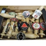 Twelve wood beer pump handles, nine with metal beer clips (2 duplicates) and three with ceramic