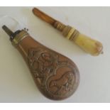 A 19th Century copper powder flask embossed with game birds and dog, 16cms long together with a 19th