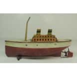 An early 20th Century German made clockwork tinplate ship with lithographic detail and painted hull,