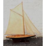 A large modern wood model of a yacht, having well detailed deck and painted hull, on stand, 99cms