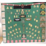 A display of Danish military metal and cloth badges, various including parachute, medical and naval
