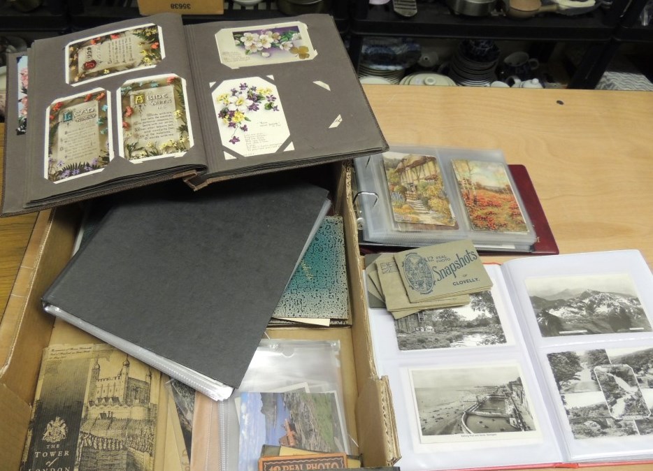 A quantity of assorted postcards contained in a variety of albums, includes churches, greetings,