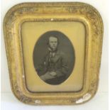 A rare whole plate ambrotype portrait of a young gentleman, seated , with gold highlighted watch