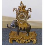 LATE 19TH CENTURY GILT METAL MANTLE CLOCK WITH ORIENTAL FIGURE OVER DIAL WITH WHITE ENAMEL
