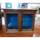 EARLY 20TH CENTURY OAK TABLE TOP CABINET WITH 2 GLASS PANEL DOORS, 69CM WIDE