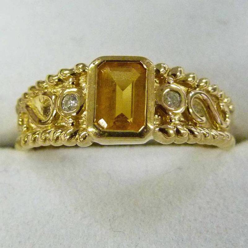 9 CARAT GOLD RING SET WITH STEP-CUT CITRINE AND WITH DIAMOND DETAIL AND DECORATIVE SETTING