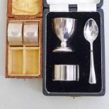 CASED SILVER PLATED CHRISTENING SET & PAIR OF SILVER NAPKIN RINGS