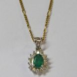 EMERALD AND DIAMOND CLUSTER PENDANT IN SETTING MARKED 18K ON FINE CHAIN MARKED 375
