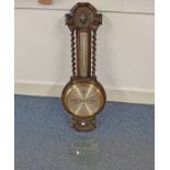 20TH CENTURY OAK ANEROID BAROMETER WITH BARLEY TWIST COLUMNS AND SILVERED DIAL