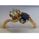 SAPPHIRE & DIAMOND 2-STONE RING, IN CROSS OVER SETTING MARKED 9CT, THE DIAMOND OF APPROX 0.40 CARAT