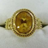 9CT GOLD AND CITRINE RING IN DECORATIVE SETTING