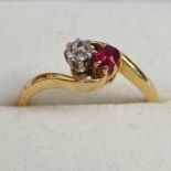 RUBY AND DIAMOND RING IN CROSS OVER SETTING INDISTINCTIVELY MARKED 18CT AND PLAT