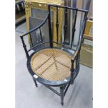 EARLY 20TH CENTURY EBONISED ARMCHAIR WITH BERGERE PANEL SEAT ON TURNED SUPPORTS