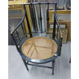 EARLY 20TH CENTURY EBONISED ARMCHAIR WITH BERGERE PANEL SEAT ON TURNED SUPPORTS