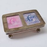 AN EARLY 20TH CENTURY .925 SILVER STAMP BOX WITH SPRING HINGE, TWO WINDOWS AND BALL FEET