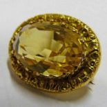 9CT GOLD MOUNTED FACETED OVAL CITRINE BROOCH