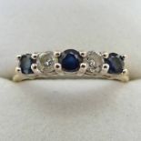 9 CARAT GOLD, SAPPHIRE AND DIAMOND HALF HOOP RING THE DIAMONDS APPROX 0.20 CARAT IN TOTAL