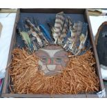 FRAMED HEADDRESS WITH FEATHERS AND CARVED WOODEN MASK, OVERALL SIZ 67 X 58CM