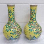 A PAIR OF 19TH CENTURY YELLOW CHINESE FAMILLE ROSE GLOBULAR VASES DECORATED WITH TREES, 6-