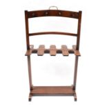 A Mahogany Boot Stand, with eight slots for boots and eight hangers, brass carrying handle, height