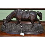 A possibly Russian bronzed cast iron figure of a horse and dog on a rocky plinth