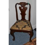 An 18th century walnut dining chair with shaped splat, drop-in seat and shell carved legs