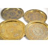 Four various Cairo Ware brass chargers 36cm, 33cm and 32cm diameter