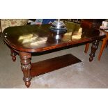A Victorian mahogany telescopic dining table with two additional leaves