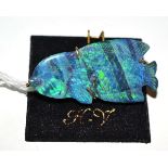 A 9ct gold opal triplet fish brooch, the carved fish in yellow claws, measures 4.2cm by 2cm