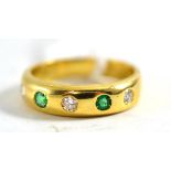 An 18ct gold emerald and diamond ring, five alternating round cut stones drill set into a plain