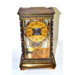 A brass champleve enamel striking mantel clock, circa 1900, four glass case with multi-coloured