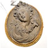 A lava cameo brooch, the portrait in high relief in a beaded and rope twist decorated frame,