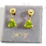 A pair of 18ct gold peridot and diamond earrings, a drop shape inset with a round brilliant cut