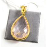 An 18ct gold rose quartz pendant, a briolette rose quartz within a yellow rubbed over setting, on